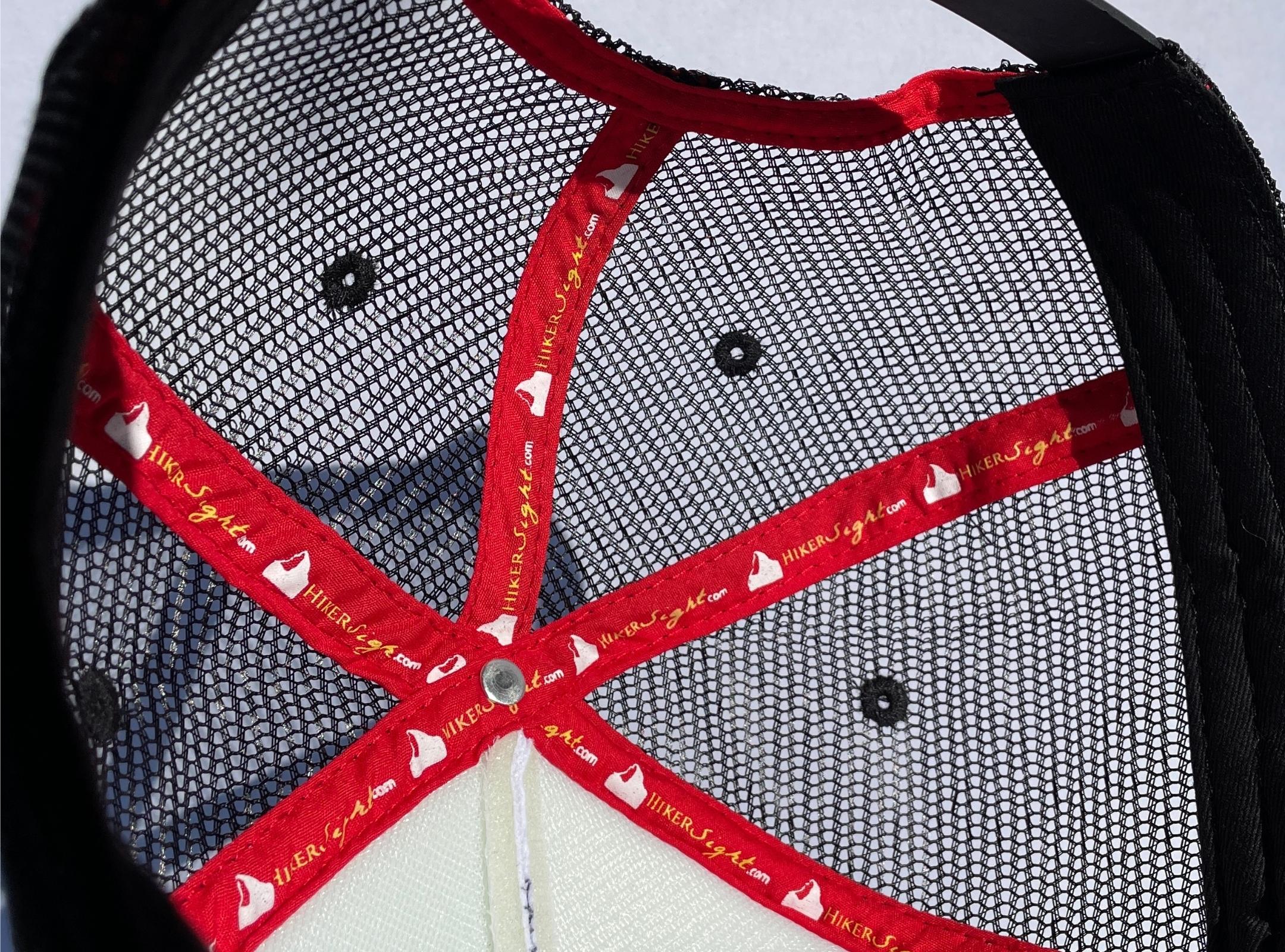 Red tapped seams on the inside of a Hiker Sight trucker hat. 