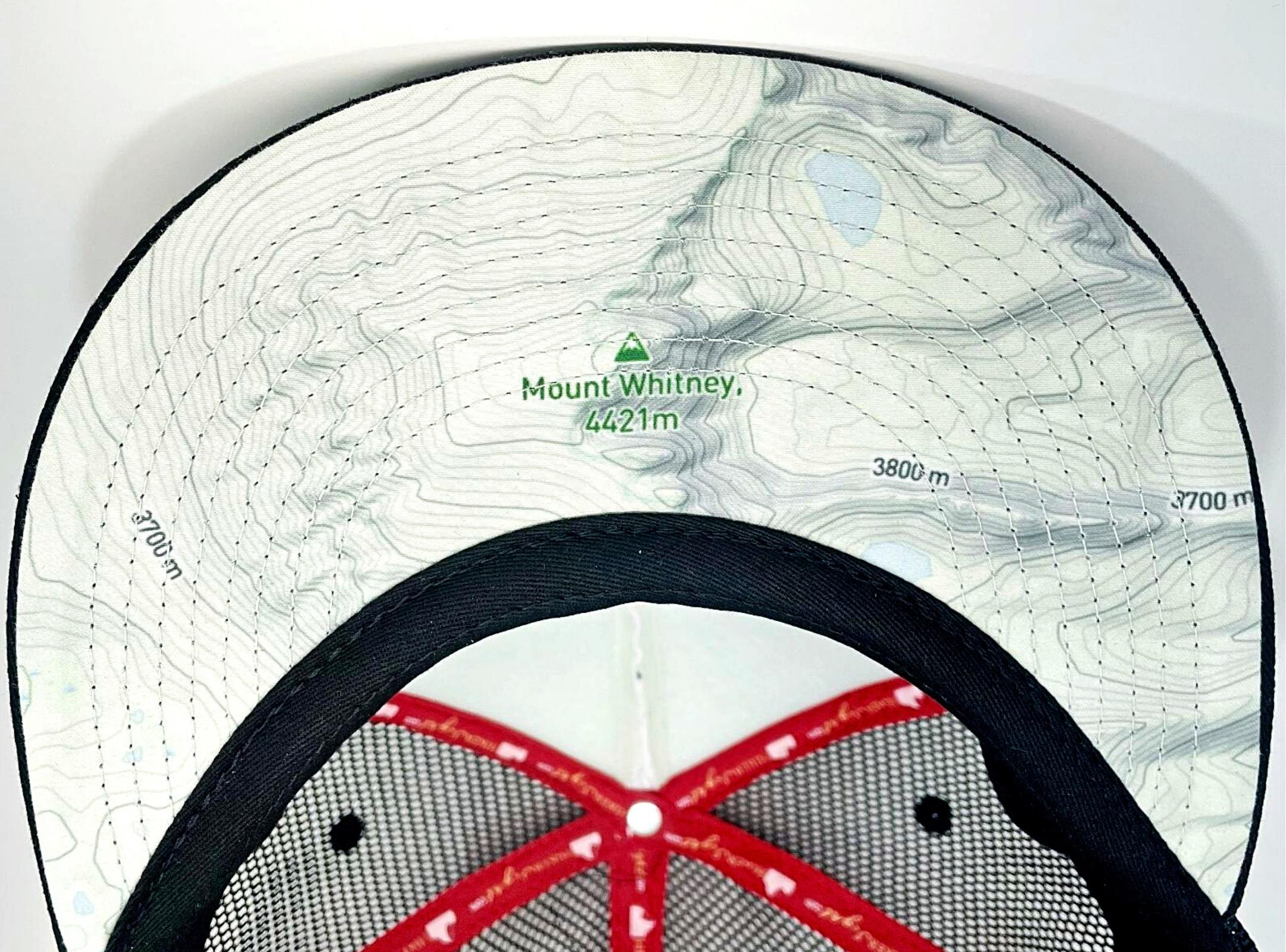 A a topographic map on the underside of a trucker hat bill or visor.
