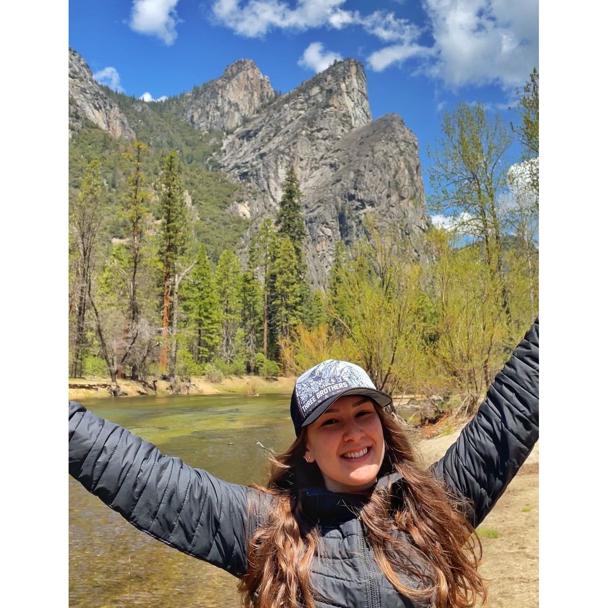 Happy girl wearing a Three Brothers trucker hat | Hiker Sight